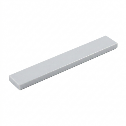 Grey 1x6 smooth building tile on a white background
