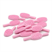 Pink hair brush accessory on a white background
